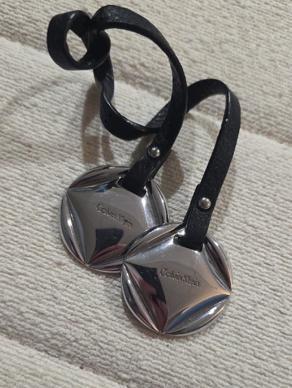 Calvin Klein Silver Disc Bag Tags with Black Leather Straps